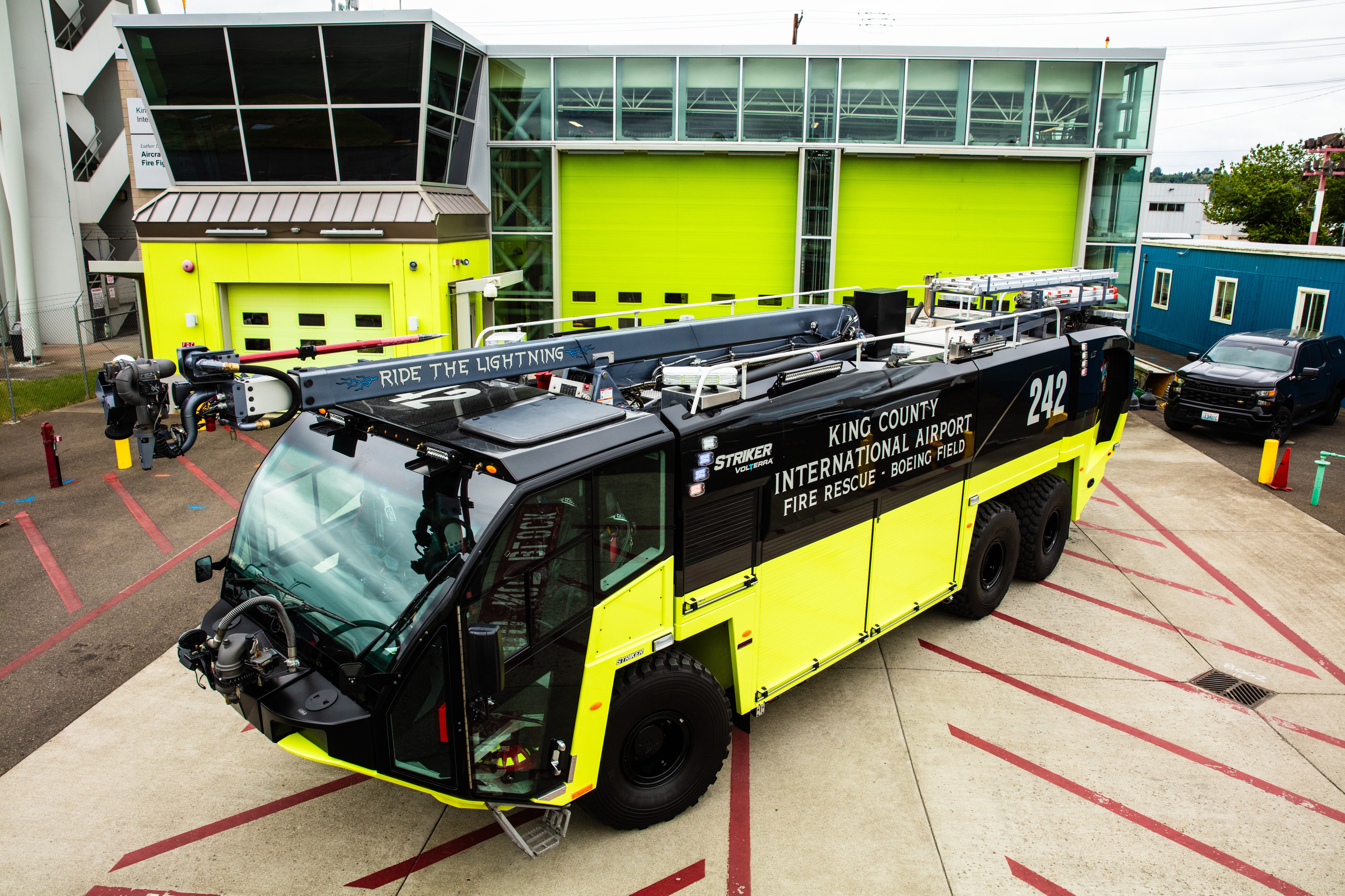 A Striker Volterra Electric ARFF parked outside near the fire station.