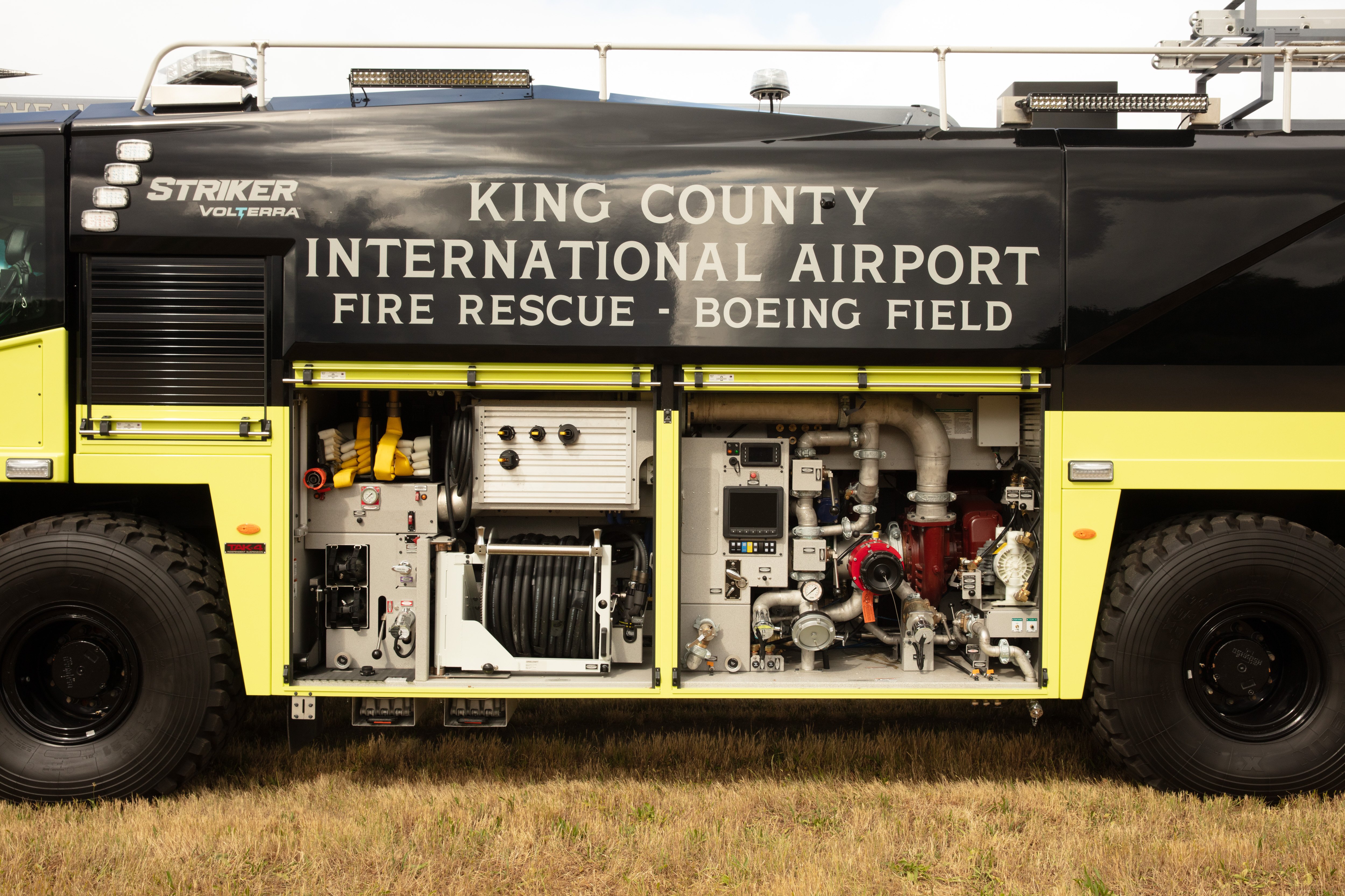 A Striker Volterra Electric ARFF with driver's side compartments open.