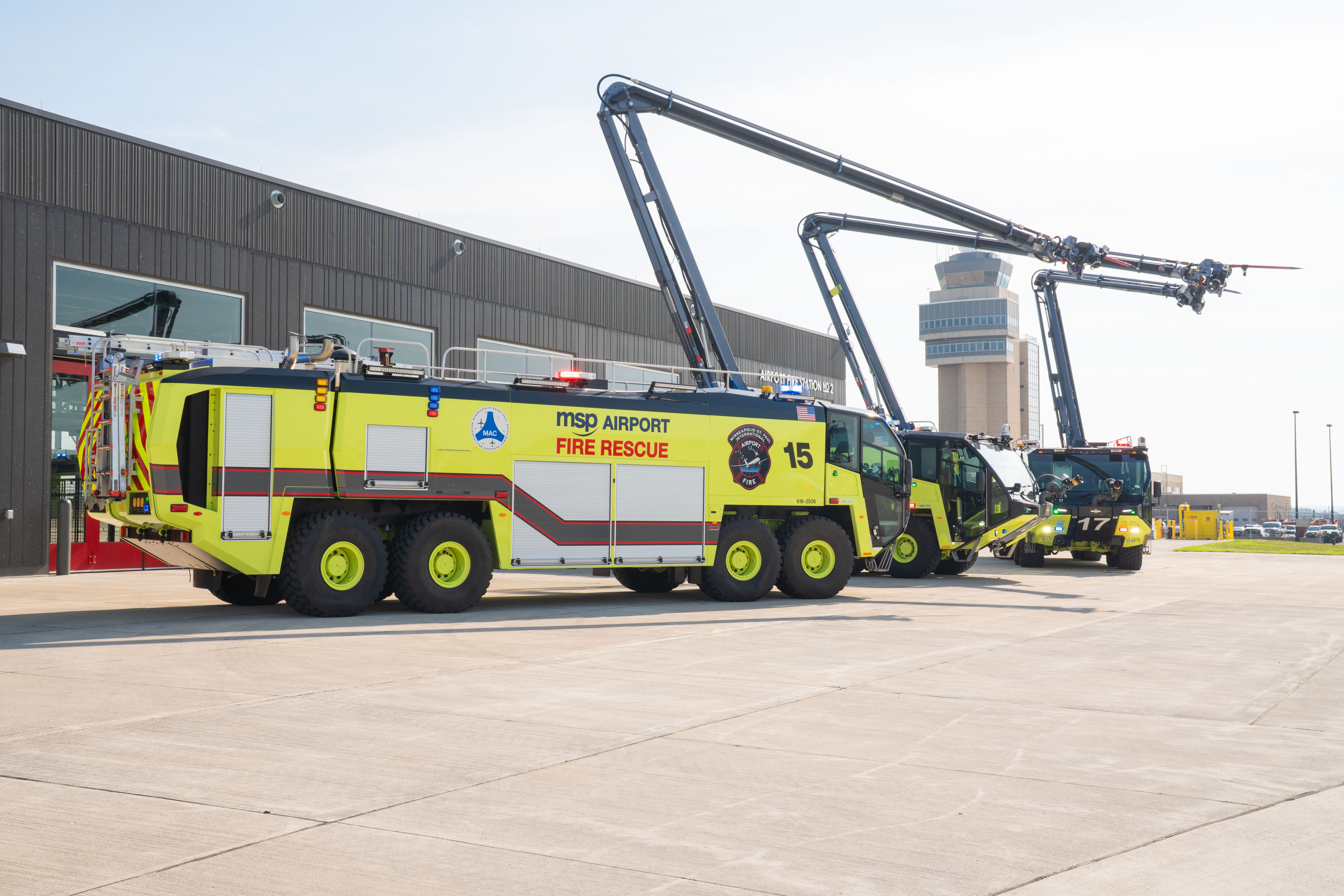Three Striker 8x8 ARFFs parked outside on a sunny day.