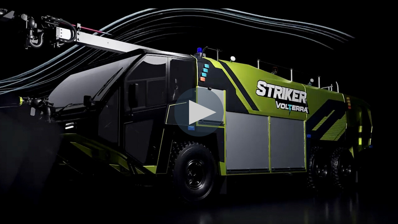 Striker Volterra electric ARFF with a Snozzle high reach extendable turret parked in a dark room. 