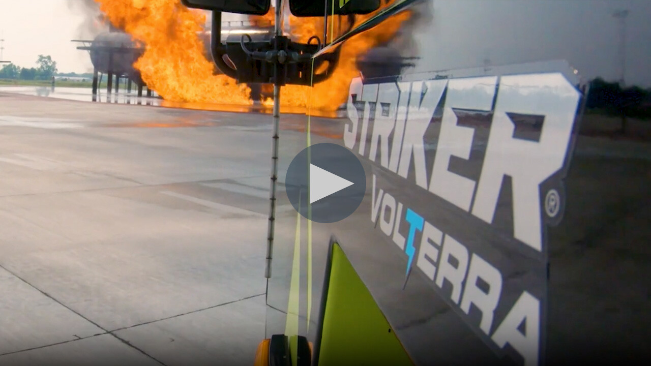 Striker Volterra electric ARFF logo on the side of a truck approaching the scene of the fire.
