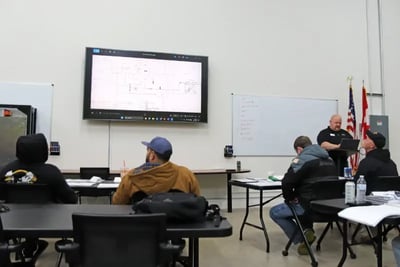 Technicians attend an ARFF technical training class focused on vehicle maintenance schematics.