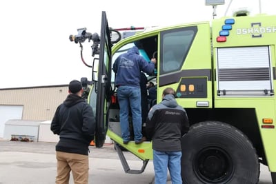 Technicians receive hands-on ARFF vehicle maintenance training with an Oshkosh fire truck.
