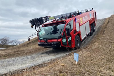 A red Striker 6x6 driving down a hill.