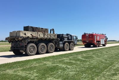 Oshkosh Airport Products ARFF vehicle conducting a drawbar test consisting of pulling another vehicle with a load cell in the tow chain - with equivalent reading of the load placed on the truck at 50 percent grade. 