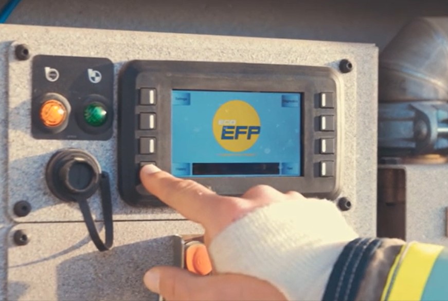 Eco EFP control panel with a firefighter's hand pressing a button.