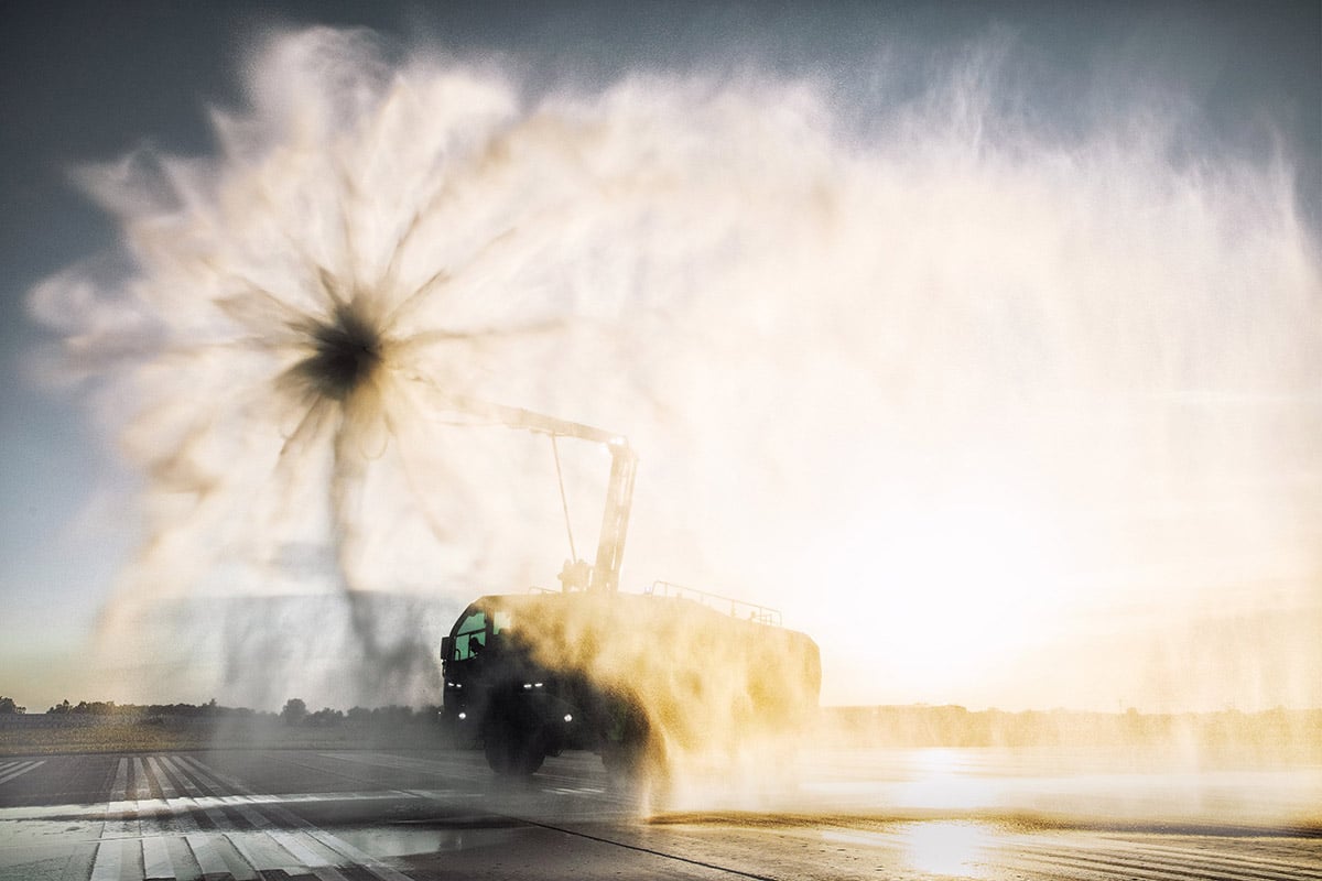 Oshkosh Striker with Snozzle extended spraying water in the air.