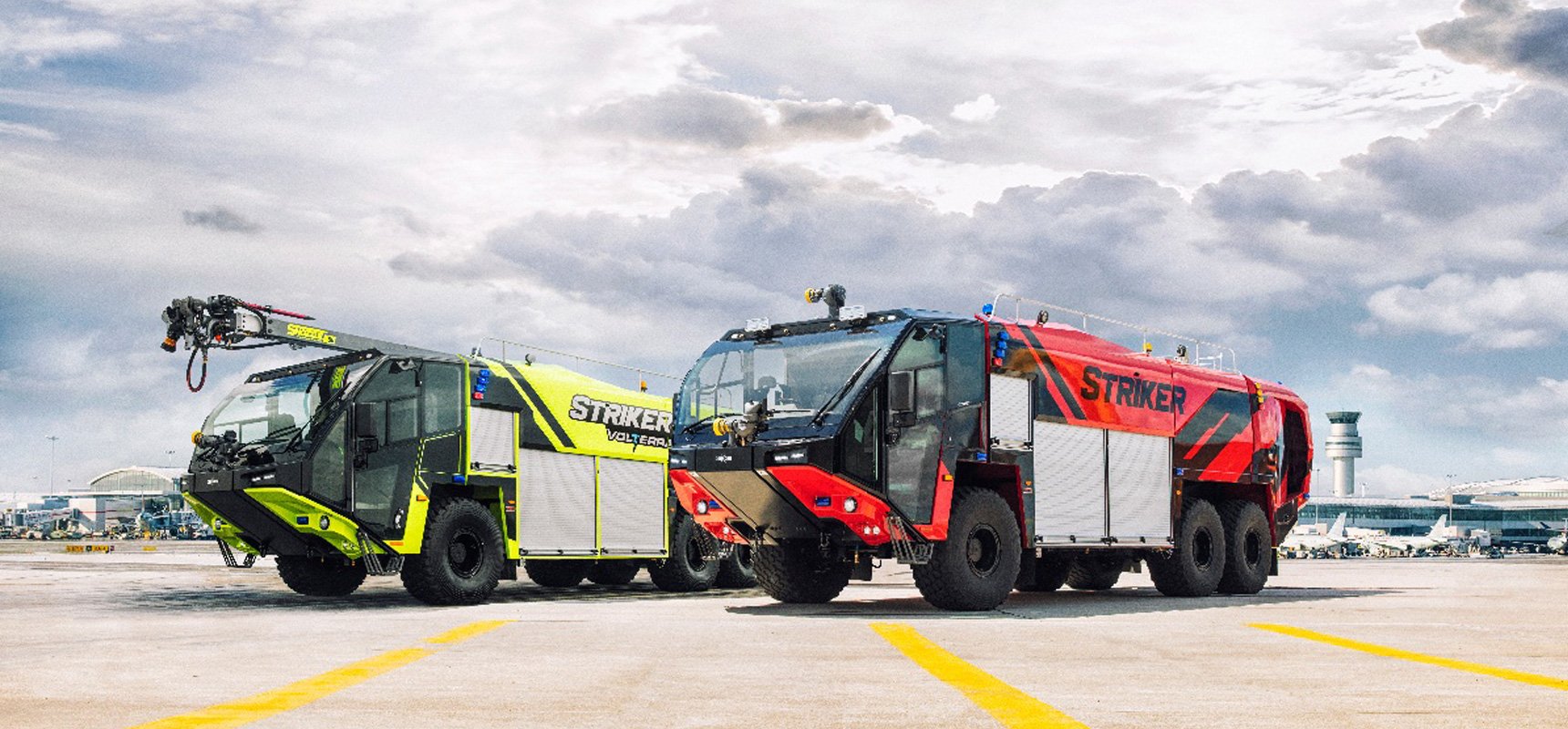 Two ARFF vehicles sitting on a runway - one is neon green and black and one is red and black