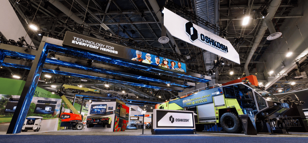 The Oshkosh booth at CES 2026 featuring the Striker Volterra Electric ARFF fire rescue vehicle.
