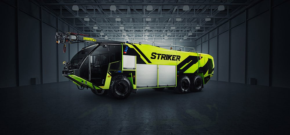Yellow Striker 6x6 ARFF truck with a Snozzle parked in facility.