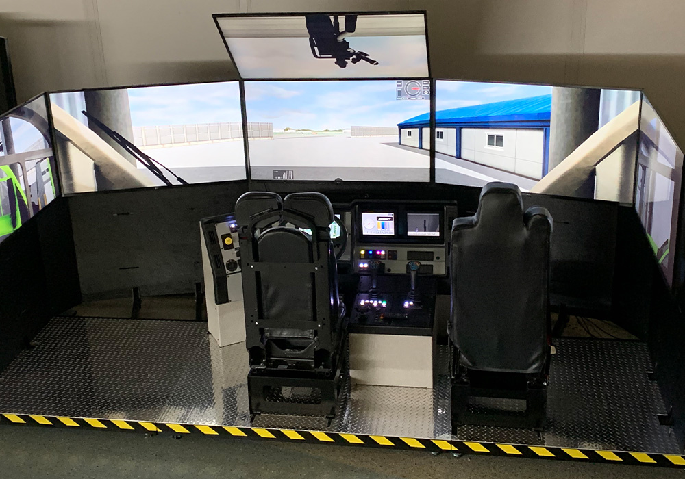 Oshkosh Striker ARFF vehicle simulator with two chairs and six screens all around.