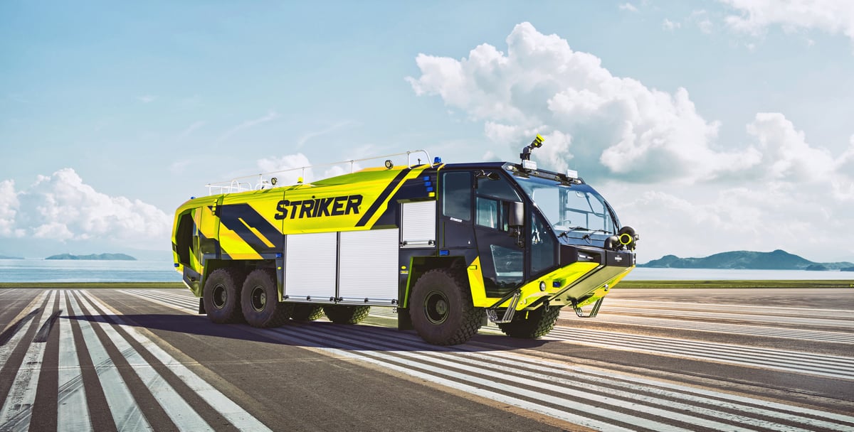 Lime green Striker 6x6 ARFF truck parked on a runway.