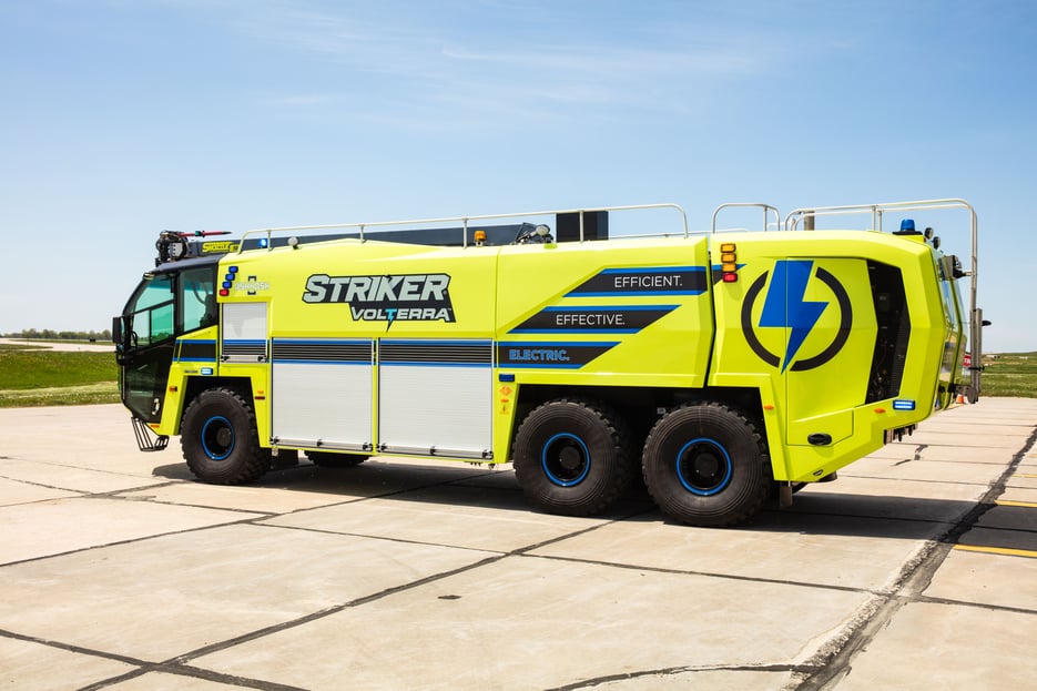 Oshkosh Airport Products' Striker Volterra electric ARFF parked outside on a sunny day.