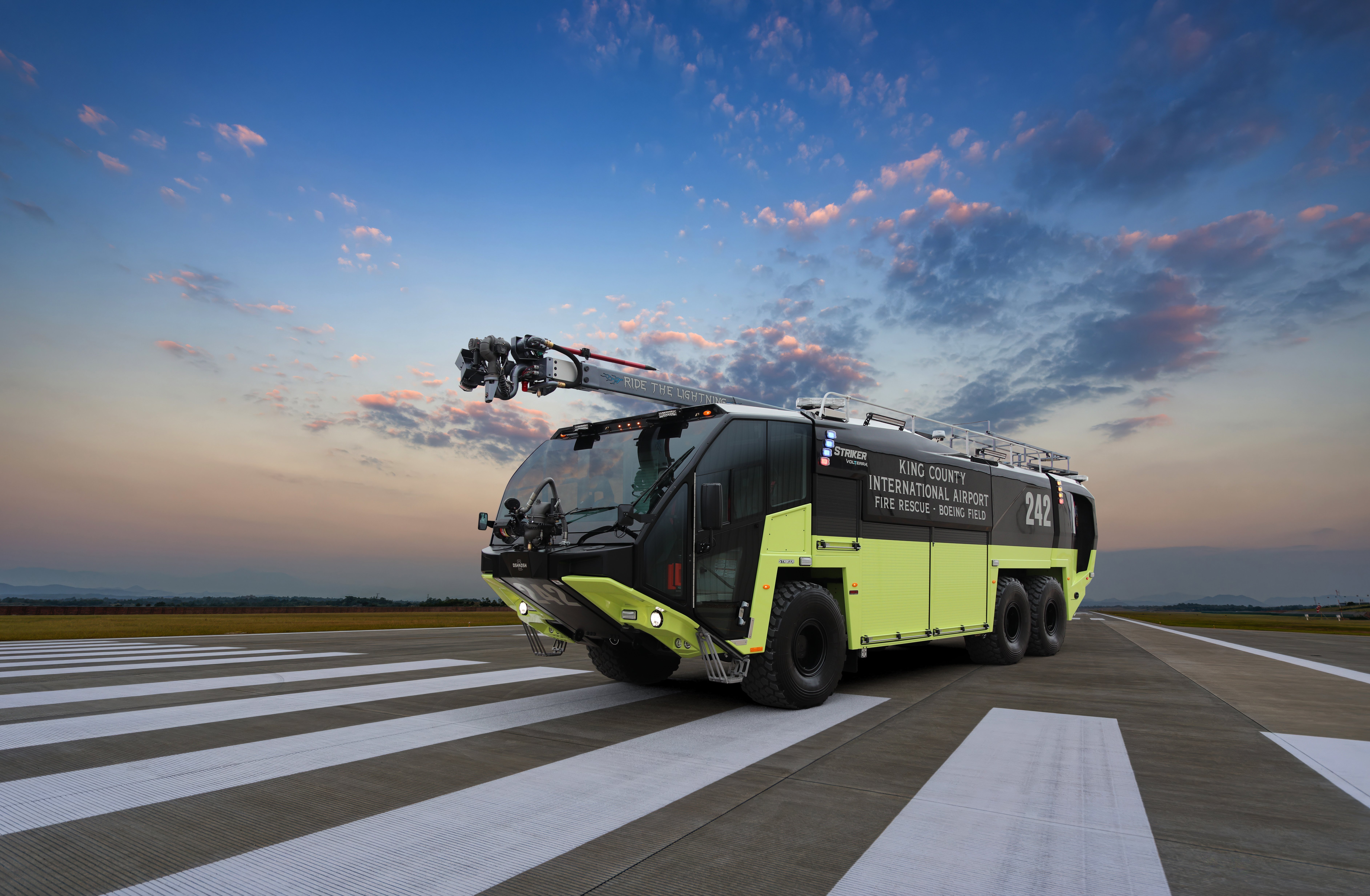 A Striker Volterra Electric ARFF for King County International Airport parked outside at sunset.