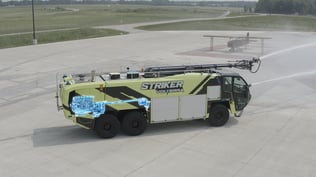 Striker Volterra electric ARFF with graphic overlay showing stationary pumping configuration.