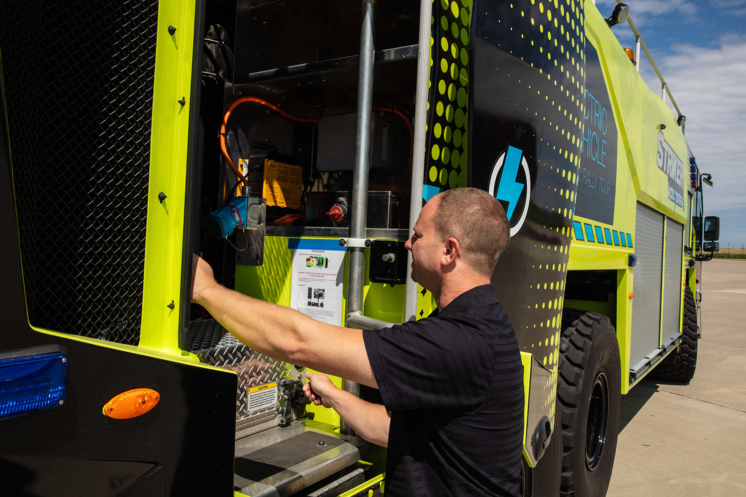 Man wearing a black shirt, looking inside the Striker Volterra.