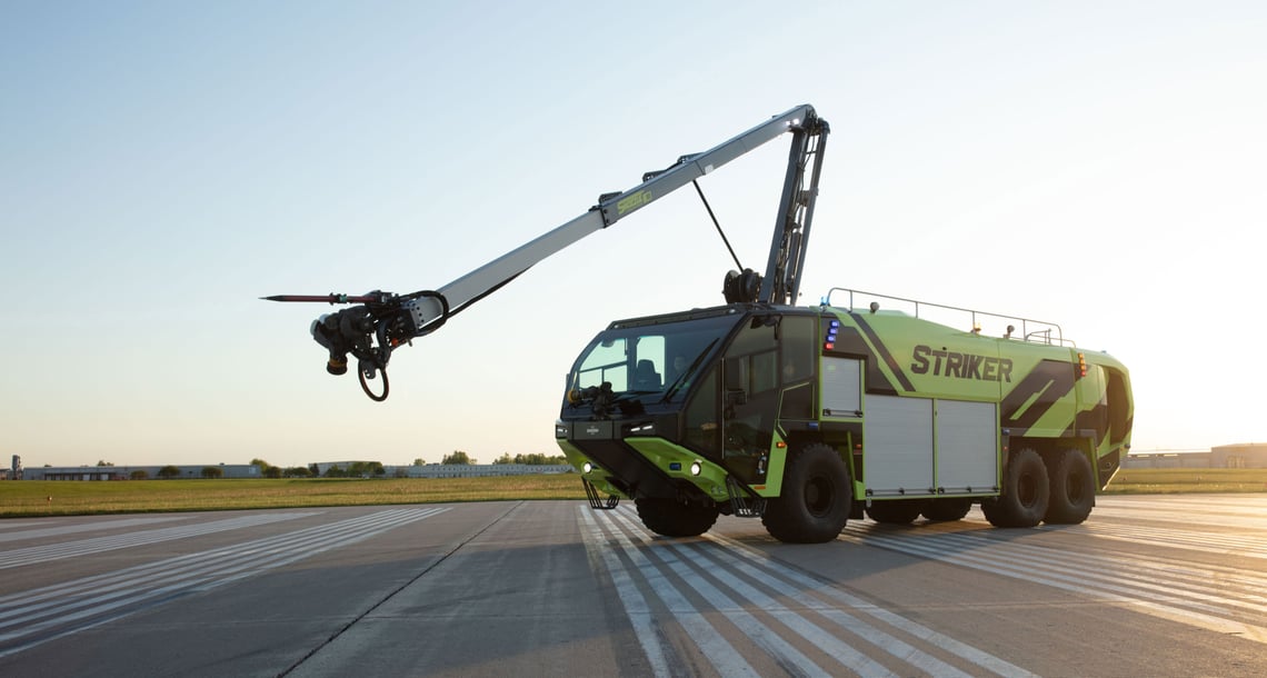 A Striker 6x6 ARFF parked outside with the Snozzle High Reach Extendable Turret extended.