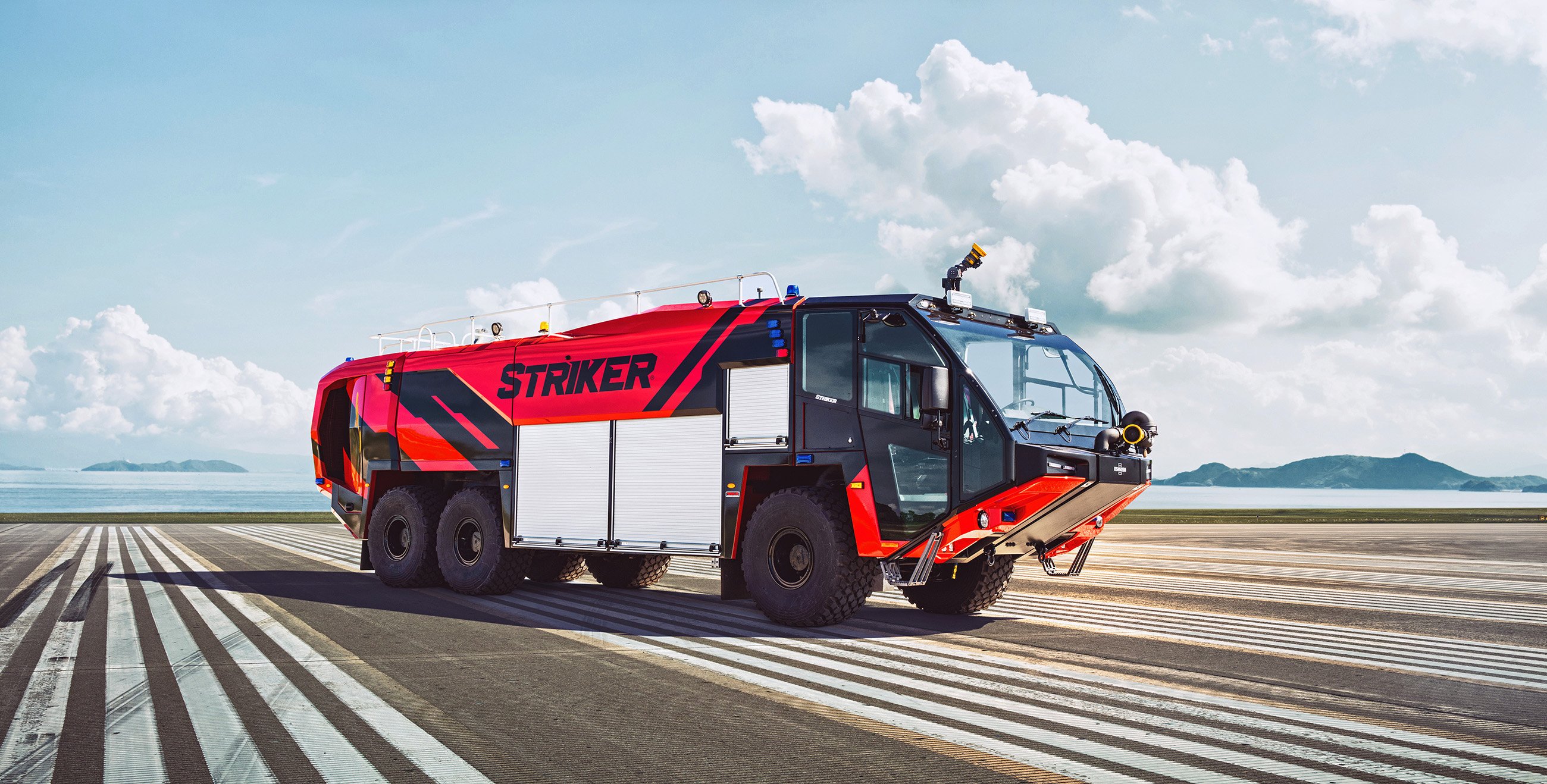 Red Oshkosh Striker ARFF truck parked on runway