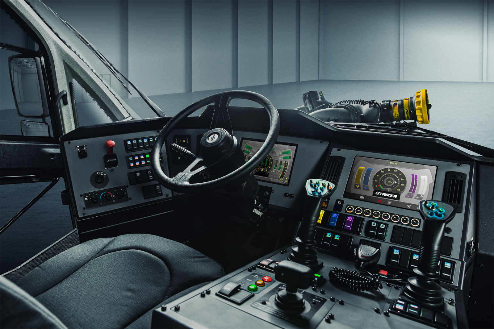 Front driver’s seat, steering wheel and controls on the interior of a Striker ARFF vehicle. 