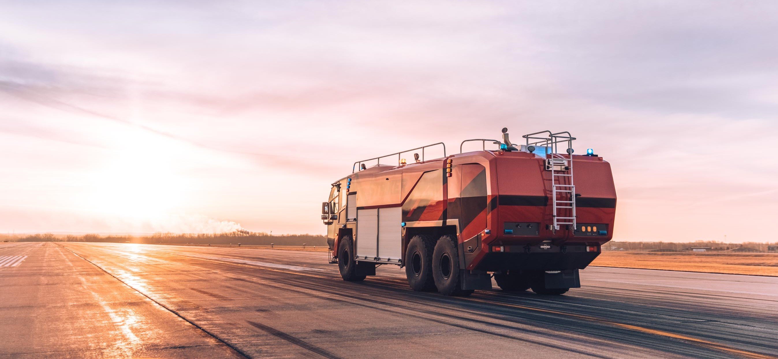 Oshkosh ARFF Vehicle on a runway at sunset