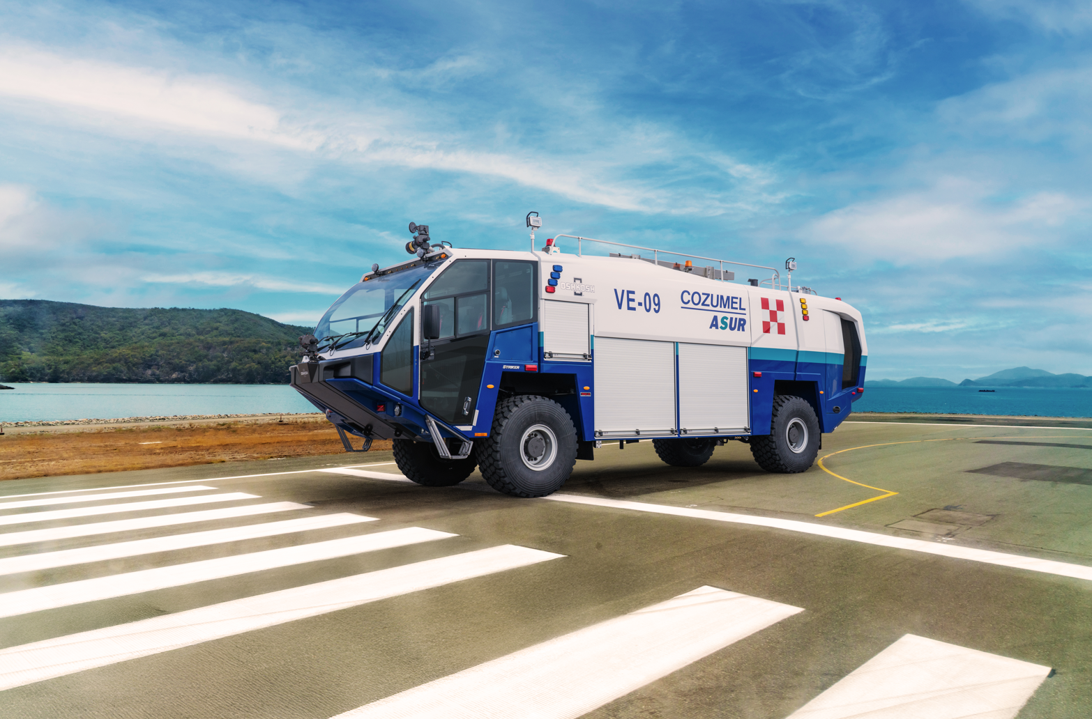 A Striker 4x4 ARFF for Cozumel International Airport parked outside on a cloudy day.