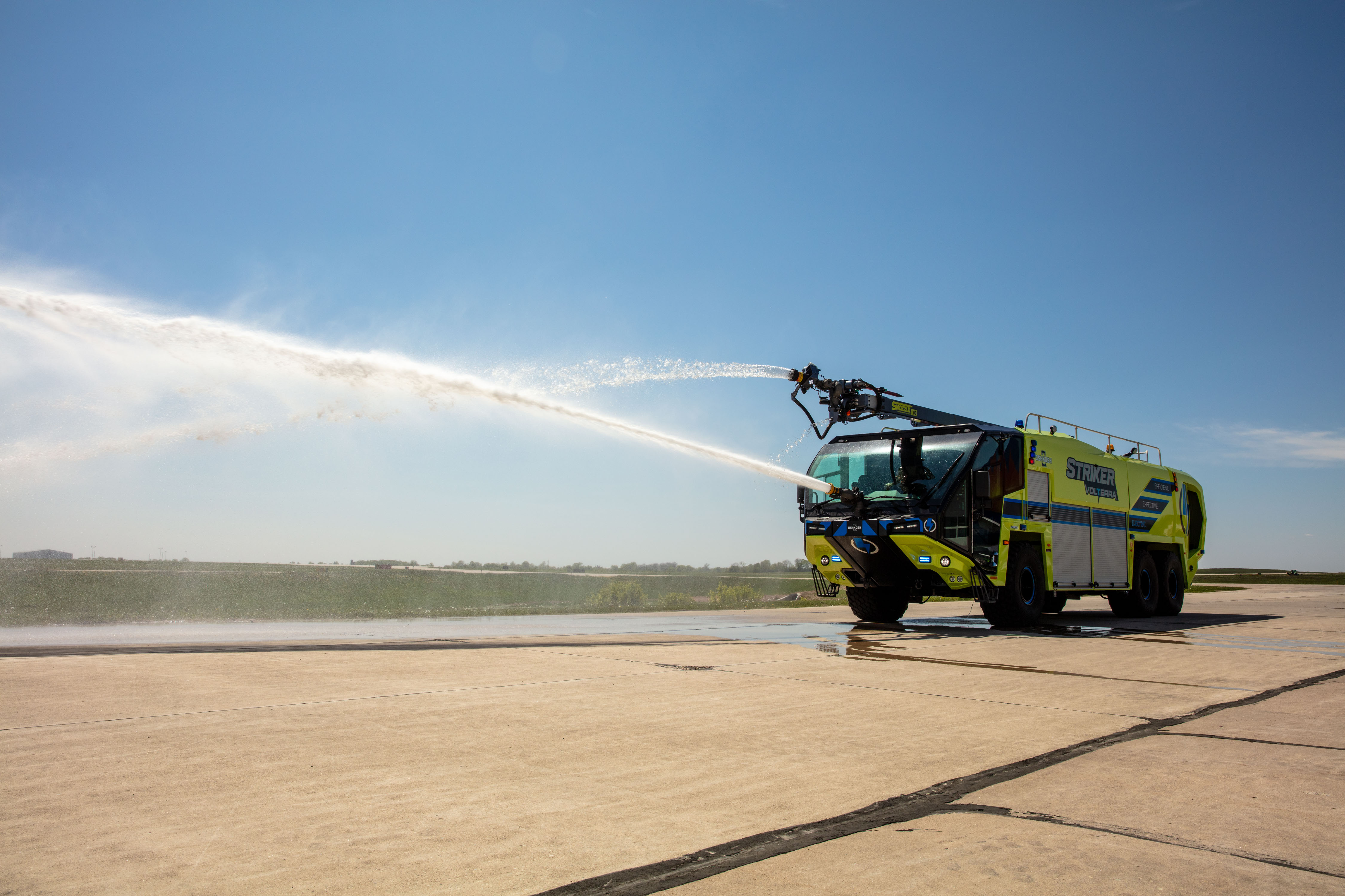 Striker Volterra Electric ARFF pumping water outside on a sunny day.